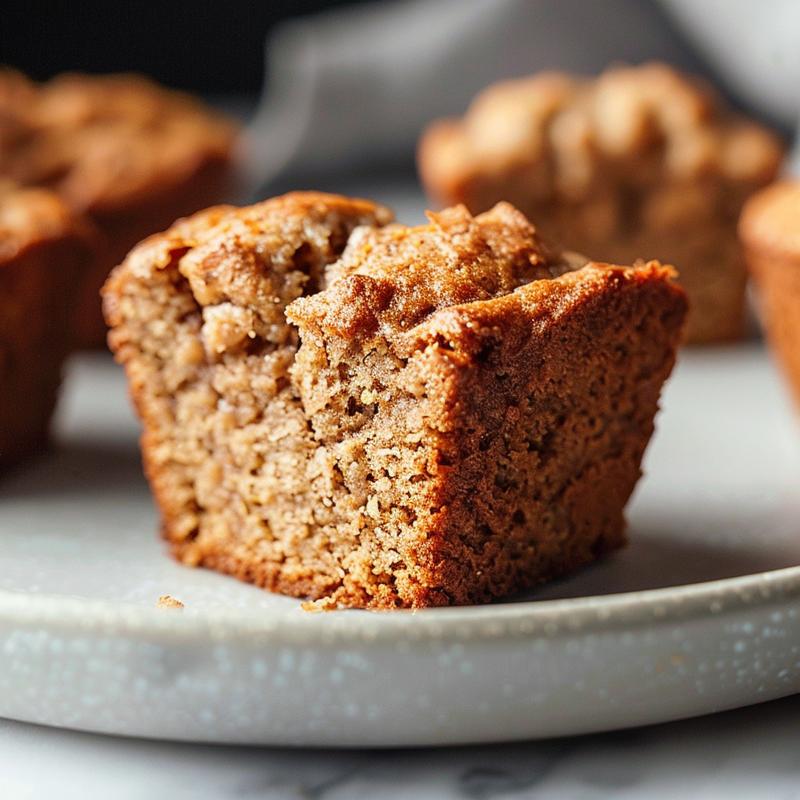 Close-up of vegan banana bread muffins on a light grey ceramic plate.